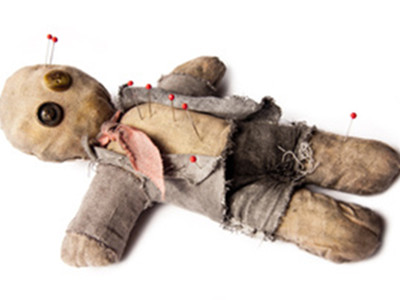 voodoo doll laying on white